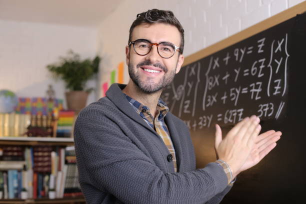 istock Satisfied teacher applauding in classroom 1328479331