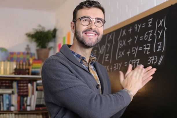 istock Satisfied teacher applauding in classroom 1328479571