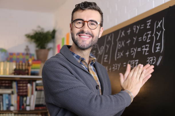 istock Satisfied teacher applauding in classroom 1328479637