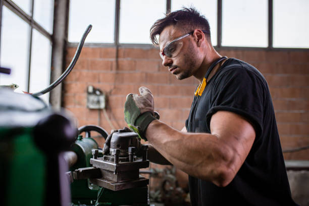 istock Turner worker, working on a lathe machine, at his metal workshop 1328479651