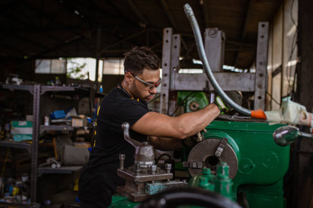 istock Milling machine operator, trying to fix the broken milling machine, at the metal workshop 1328479812