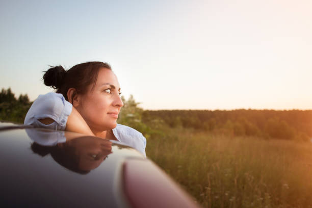 istock beautiful brunette looks at the sunset, close-up 1328480734