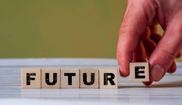 istock The hand put wooden cube block and creates word FUTURE. Goodbye coronavirus and new future. Covid19 new normal 1328482024