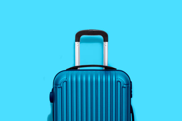 istock Blue stylish travel suitcase isolated on blue background 1328482348