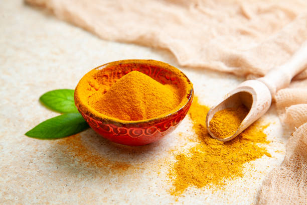 istock Dried turmeric powder with leaves on a light background 1328484989