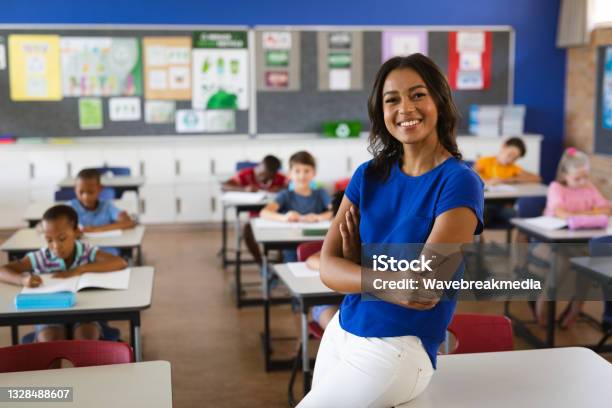 Portrait Of African American Female Teacher Smiling In The Class At School Stock Photo - Download Image Now