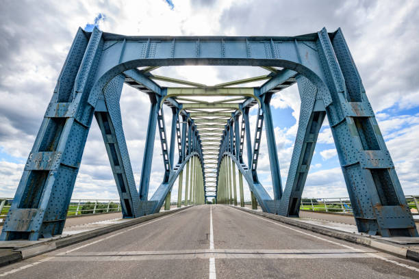 Old IJsselbrug over the river IJssel between Zwolle and Hattem. View from the middle of the road on the old steel arch bridge.