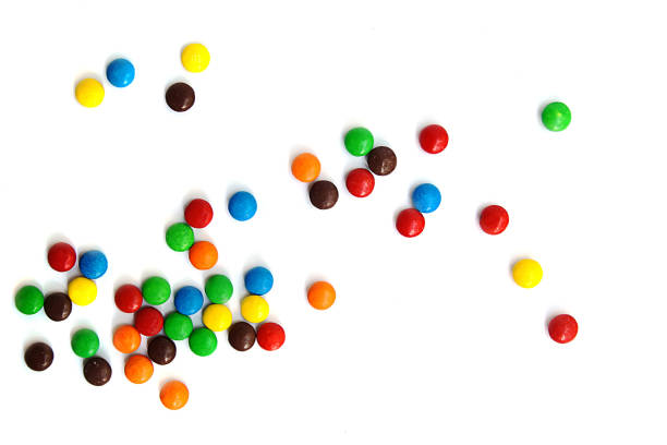 istock A scattering of colored small chocolates on a white background. Small colored candies 1328492074