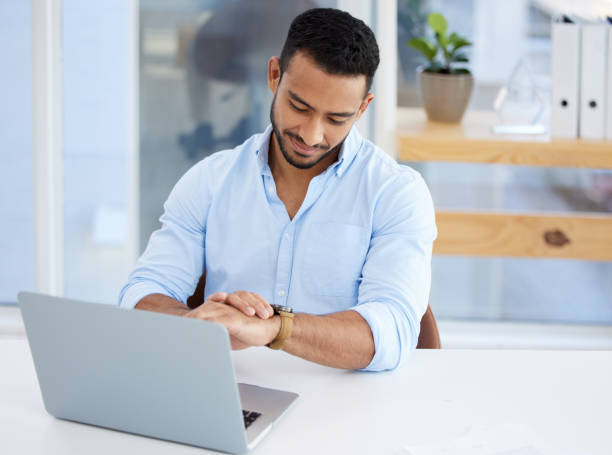 istock Shot of a young businessman checking the time at work 1328492621