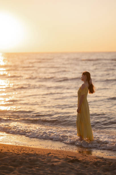 istock Beautiful woman on the beach at sunset. ​ 1328492757