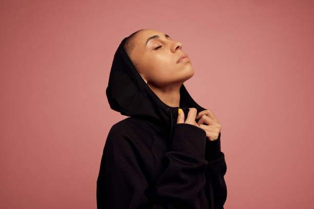 istock Androgynous woman in black hoodie jacket 1328492937