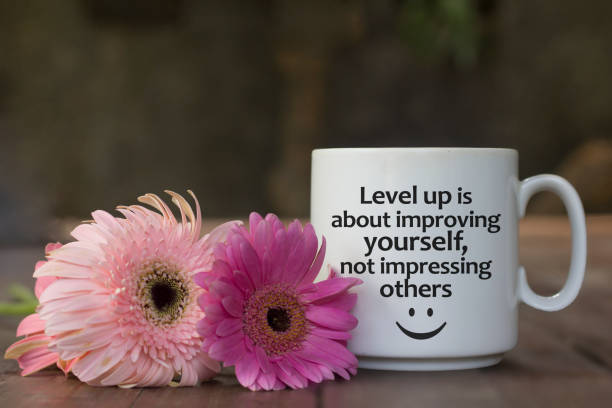 istock Positive message on coffee cup with flowers on the table - Level up is about improving yourself, not impressing others. 1328493052