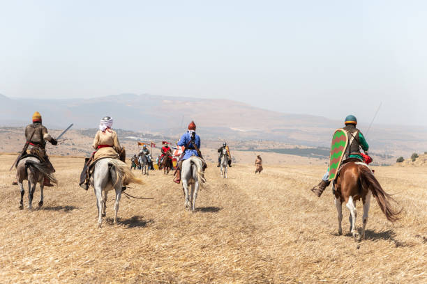 Horse and foot warriors - participants in the reconstruction of Horns of Hattin battle in 1187, are on the battle site, near TIberias, Israel Tiberias, Israel, July 02, 2021 : Horse and foot warriors - participants in the reconstruction of Horns of Hattin battle in 1187, are on the battle site, near TIberias, Israel ergani escort stock pictures, royalty-free photos & images