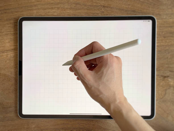 istock Right hand writing on tablet with touch pen 1328495150