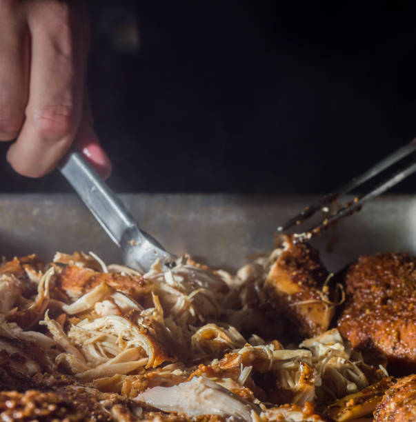 istock chicken in a roasting pan being shredded 1328496351