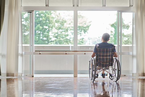 Elderly people in wheelchairs in long-term care facilities