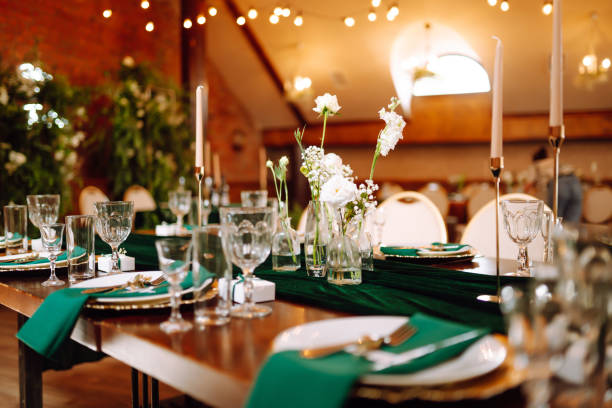 istock Wedding. Banquet. Beautiful table setting for a party, wedding reception or other festive event emerald colour. 1328496551