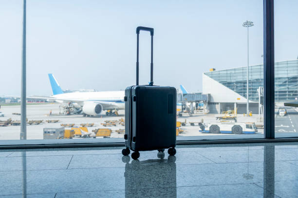 istock A black suitcase in the airport terminal 1328496774
