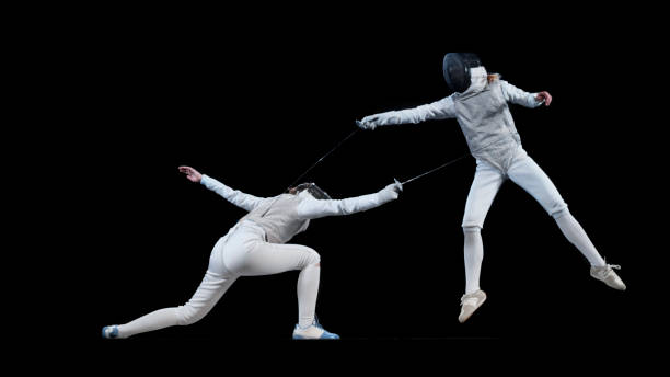 istock Female fencing athletes competing . 1328496816