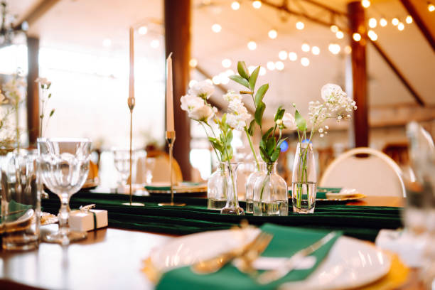 istock Beautiful flowers on table in wedding day. Beautiful table setting for a party, reception or other festive event emerald colour. 1328499480