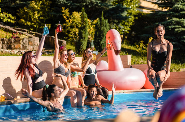istock Group of girlfriends at a poolside summer party. 1328500677