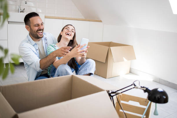 istock Young couple having fun online while moving in 1328503369