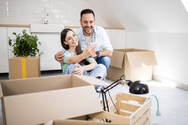 istock Happy couple taking a selfie while moving in 1328503382