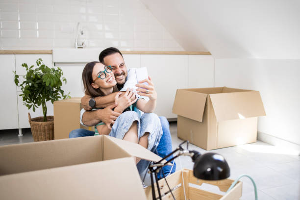 istock Happy couple enjoying while moving in and taking a selfie 1328503390