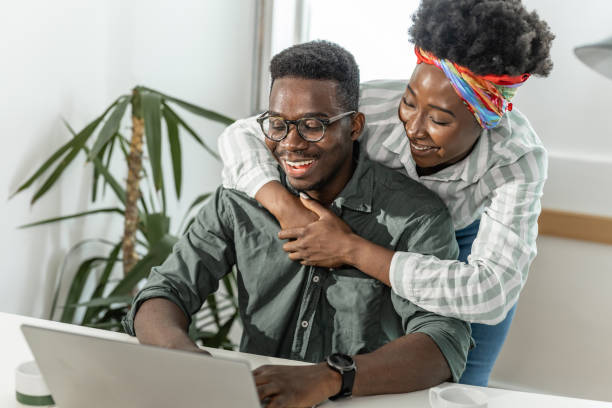 istock A young couple is looking at the laptop screen and embracing 1328503668