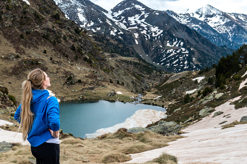 Woman relaxing in Pyrenees mountains and looking at view.