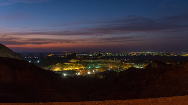 Beautiful views of the city of Al Ain at dusk Beautiful views of the city of Al Ain from the atop the Jebel Hafeet mountain in the city of Al Ain in the United Arab Emirates. Views of the city at dusk. jebel hafeet stock pictures, royalty-free photos & images