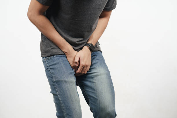 Young man holding his crotch suffering from Diarrhea, incontinence, prostatitis, venereal disease. Healthcare concept. Young man holding his crotch suffering from Diarrhea, incontinence, prostatitis, venereal disease. Healthcare concept. penis photos stock pictures, royalty-free photos & images