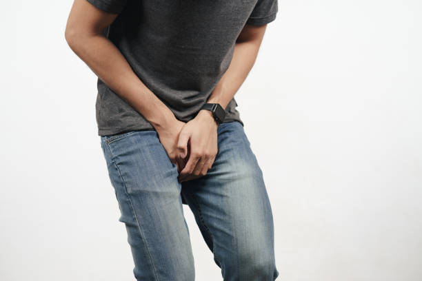 young man holding his crotch suffering from diarrhea, incontinence, prostatitis, venereal disease. healthcare concept. - garment emotional stress equipment household equipment imagens e fotografias de stock