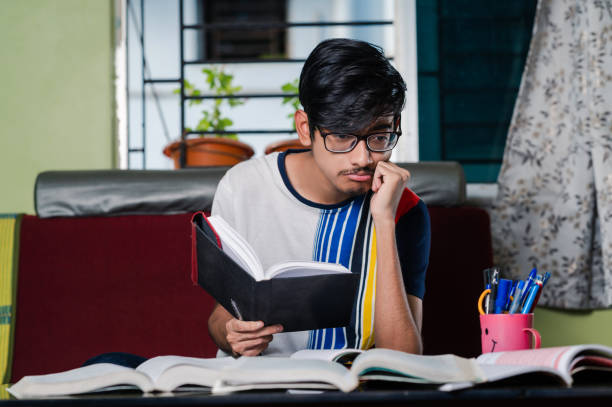 istock Young boy preparing for exam, Studying  online at home. 1328511368