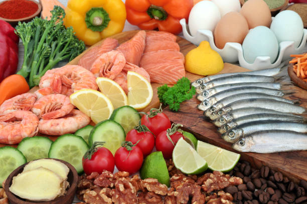 Pescatarian Healthy Balanced Diet Diet Food Pescatarian healthy food concept for an immune system boosting balanced diet high in protein and omega 3 with a collection of vegetables and fruit. Foods to help lower cholesterol and blood pressure. crustacean photos stock pictures, royalty-free photos & images