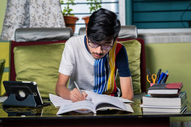istock Young boy studying at home using digital tablet and Mobile phone. 1328511467