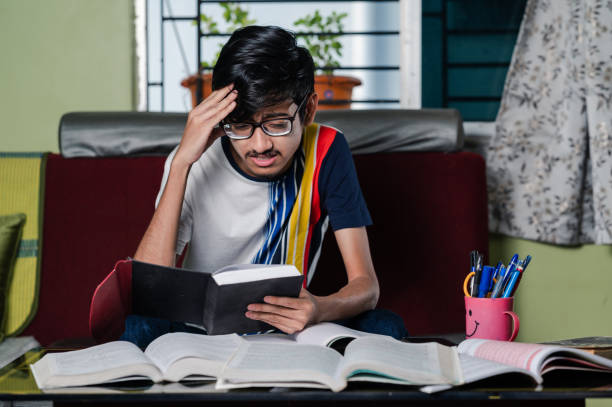 istock Young boy preparing for exam, Studying  online at home. 1328511912