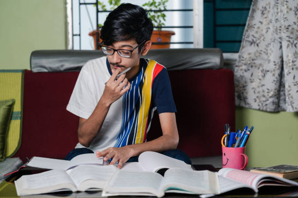 istock Young boy preparing for exam, Studying  online at home. 1328512132