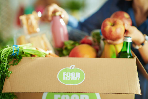istock Closeup on woman with food box in kitchen 1328513533
