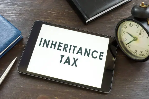 Photo of Inheritance tax words on the tablet and notepad.