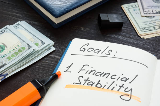 istock Written goals financial stability on the notepad page. 1328513731