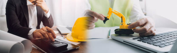 istock engineer working at a drawings of house in office for discussing. Engineering tools and construction concept. 1328513810