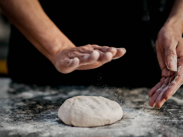 istock Hands knead the dough (powder) for pizza making 1328516245