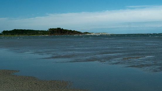 a long view of the area called The Point in Cherry Grove where the inlet meets the ocean