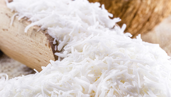 grated coconut wooden spoon, coconut-based ingredient