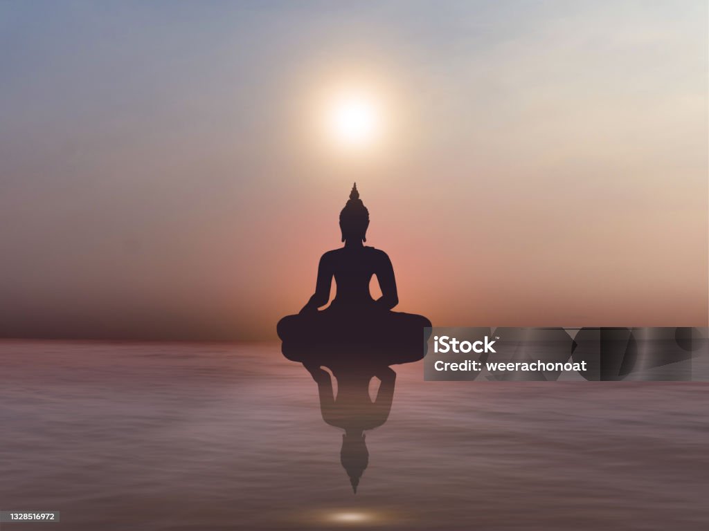 Silhouette of Buddha statue on golden sunset at river. Buddhism background Buddha Stock Photo