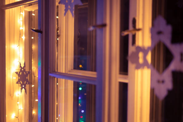 istock Christmas lights, Christmas paper star in Window 1328518102