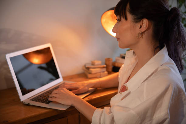 istock Young woman working at laptop 1328519744