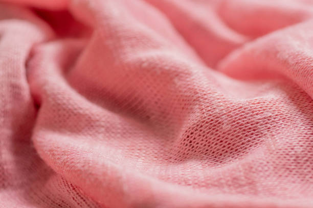 istock Pink knitted synthetic fabric texture background. 1328520044