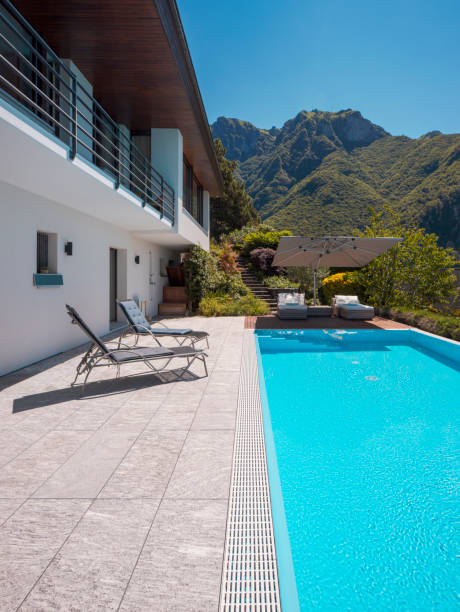 istock Modern two-story house with large pool overlooking the mountains. 1328520111